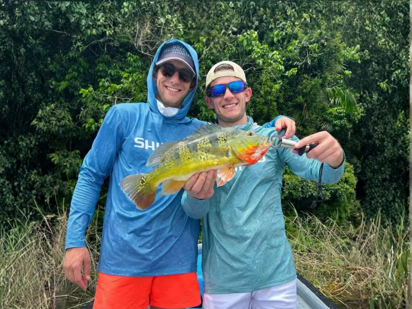 Two anglers with a peacock bass caught in the Panama Canal
